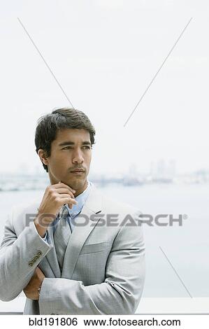 Stock Photograph - Hispanic businessman looking pensive. Fotosearch