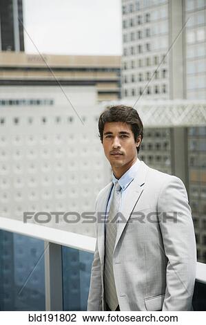 Hispanic businessman on urban balcony View Large Photo Image Stock Image - Hispanic businessman on urban balcony. Fotosearch