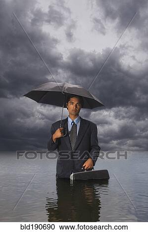 Hispanic businessman standing in water View Large Photo Image Stock Image - Hispanic businessman standing in water. Fotosearch