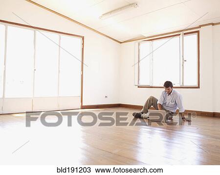 Hispanic businessman using laptop on floor in empty office View Large Photo Image Stock Image - Hispanic businessman using laptop on floor in empty office. Fotosearch