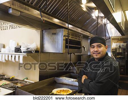 Hispanic chef smiling in kitchen View Large Photo Image Stock Image - Hispanic chef smiling in kitchen. Fotosearch