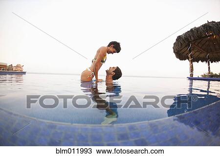 Hispanic couple enjoying swimming pool View Large Photo Image Stock Image - Hispanic couple enjoying swimming pool. Fotosearch
