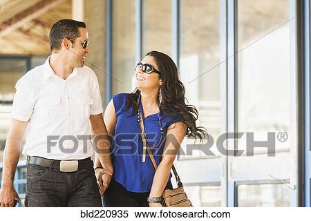 Hispanic couple holding hands in city View Large Photo Image Stock Photography - Hispanic couple holding hands in city. Fotosearch