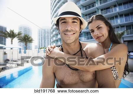 Hispanic couple hugging poolside View Large Photo Image Stock Photo - Hispanic couple hugging poolside. Fotosearch