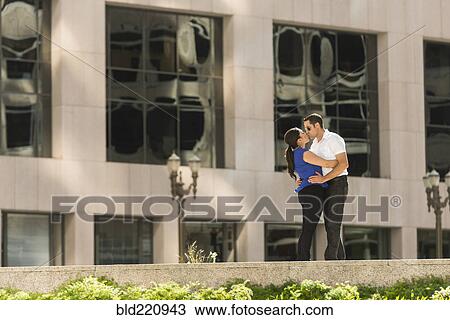 Hispanic couple kissing in city View Large Photo Image Stock Image - Hispanic couple kissing in city. Fotosearch