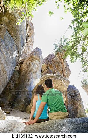 Hispanic couple looking at rock formation View Large Photo Image Stock Image - Hispanic couple looking at rock formation. Fotosearch