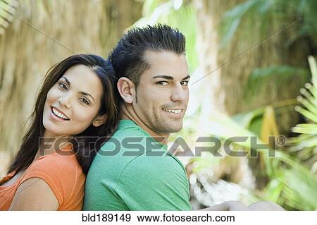 Stock Photo - Hispanic couple relaxing in tropical area. Fotosearch