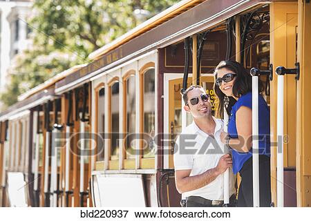 Stock Photo - Hispanic couple riding cable car. Fotosearch