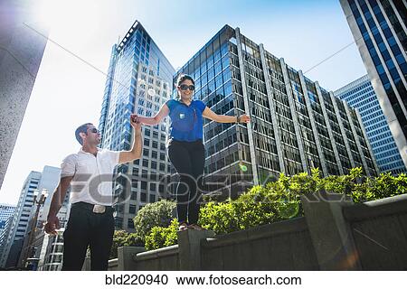 Stock Image - Hispanic couple walking in city. Fotosearch