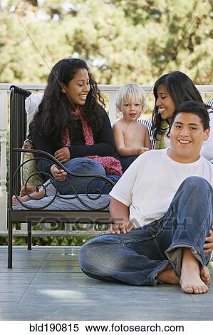 Hispanic family sitting on porch View Large Photo Image Stock Photography - Hispanic family sitting on porch. Fotosearch