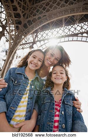 Stock Photo - Hispanic family visiting Eiffel Tower. Fotosearch