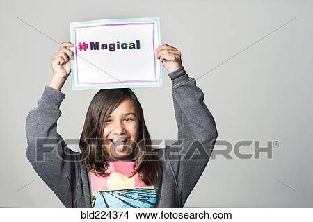 Hispanic girl holding magical sign above head View Large Photo Image Picture - Hispanic girl holding magical sign above head. Fotosearch