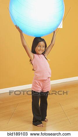 Hispanic girl lifting exercise ball View Large Photo Image Stock Image - Hispanic girl lifting exercise ball. Fotosearch