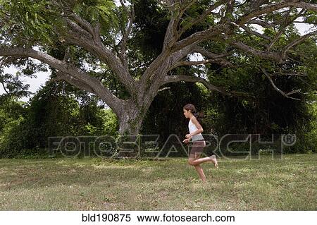 Hispanic girl running barefoot through grass View Large Photo Image Stock Photography - Hispanic girl running barefoot through grass. Fotosearch