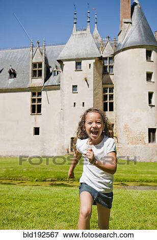 Hispanic girl running with castle in background View Large Photo Image Stock Photo - Hispanic girl running with castle in background. Fotosearch