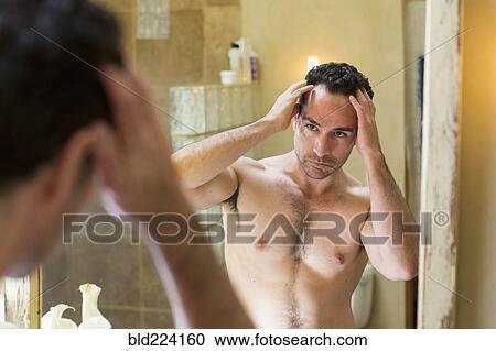 Hispanic man checking receding hairline in mirror View Large Photo Image Stock Image - Hispanic man checking receding hairline in mirror. Fotosearch