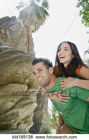 Hispanic man giving girlfriend piggyback ride View Large Photo Image Stock Photograph - Hispanic man giving girlfriend piggyback ride. Fotosearch