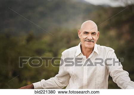 Stock Image - Hispanic man smiling outdoors. Fotosearch