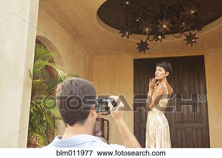 Hispanic man taking photograph of wife View Large Photo Image Stock Photo - Hispanic man taking photograph of wife. Fotosearch