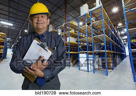 Hispanic man working in warehouse View Large Photo Image Stock Photo - Hispanic man working in warehouse. Fotosearch