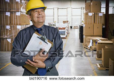 Hispanic man working in warehouse View Large Photo Image Stock Photograph - Hispanic man working in warehouse. Fotosearch