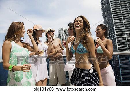 Hispanic men and women partying on rooftop View Large Photo Image Stock Image - Hispanic men and women partying on rooftop. Fotosearch