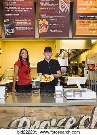Hispanic server and businesswoman smiling in cafe View Large Photo Image Stock Photography - Hispanic server and businesswoman smiling in cafe. Fotosearch