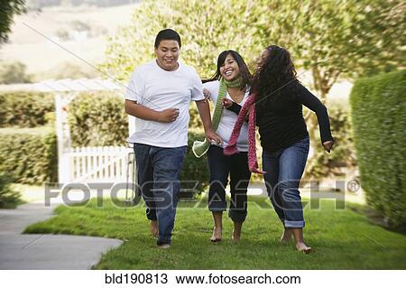 Hispanic siblings running on grass View Large Photo Image Stock Image - Hispanic siblings running on grass. Fotosearch
