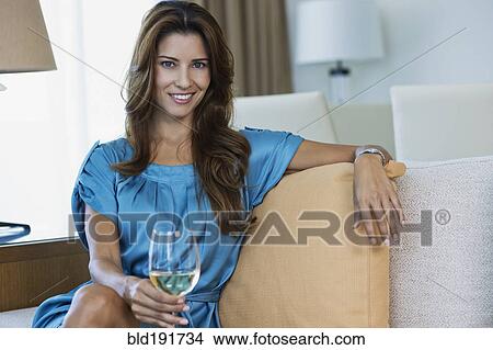 Picture - Hispanic woman drinking white wine. Fotosearch
