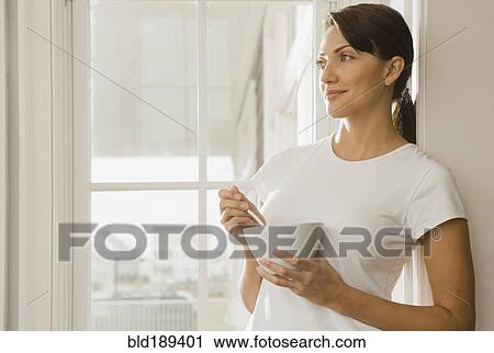Hispanic woman eating from bowl View Large Photo Image Stock Image - Hispanic woman eating from bowl. Fotosearch
