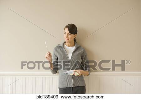 Stock Photo - Hispanic woman holding color swatches. Fotosearch