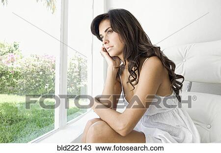 Hispanic woman looking out window View Large Photo Image Stock Image - Hispanic woman looking out window. Fotosearch