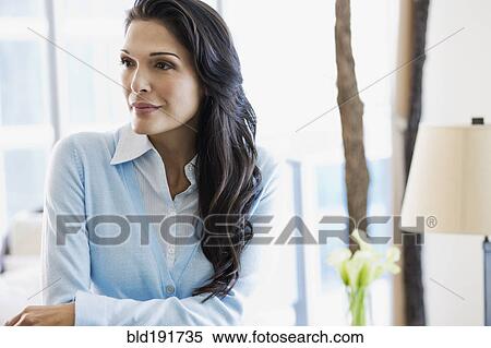 Stock Photography - Hispanic woman looking pensive. Fotosearch