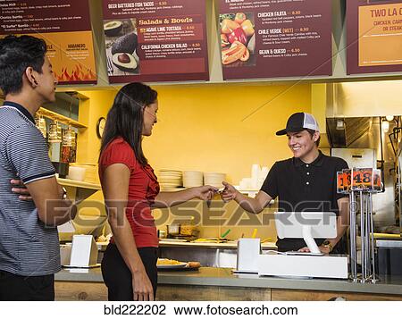 Hispanic woman purchasing food in cafe View Large Photo Image Stock Image - Hispanic woman purchasing food in cafe. Fotosearch