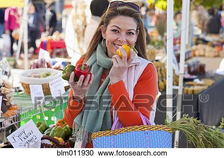 Hispanic woman shopping at farmer's market View Large Photo Image Stock Image - Hispanic woman shopping at farmer's market. Fotosearch