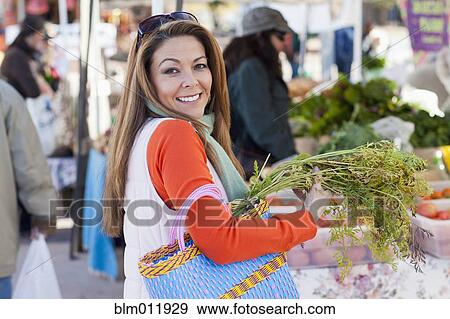 Hispanic woman shopping at farmer's market View Large Photo Image Stock Photo - Hispanic woman shopping at farmer's market. Fotosearch