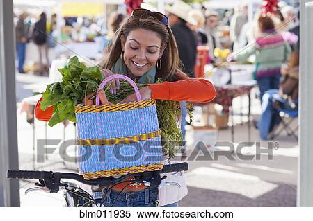 Hispanic woman shopping at farmer's market View Large Photo Image Stock Photography - Hispanic woman shopping at farmer's market. Fotosearch