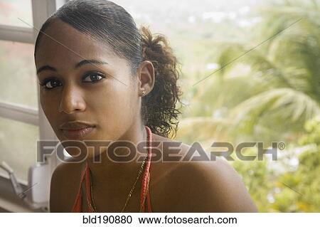 Hispanic woman sitting near window View Large Photo Image Stock Image - Hispanic woman sitting near window. Fotosearch