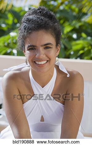 Stock Photo - Hispanic woman sitting outdoors. Fotosearch