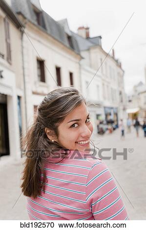 Hispanic woman walking in town View Large Photo Image Stock Image - Hispanic woman walking in town. Fotosearch
