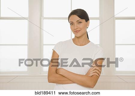 Stock Image - Hispanic woman with arms crossed. Fotosearch