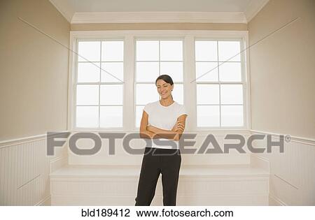 Stock Image - Hispanic woman with arms crossed. Fotosearch
