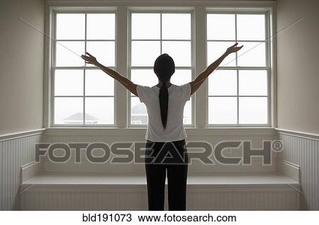 Stock Image - Hispanic woman with arms outstretched. Fotosearch