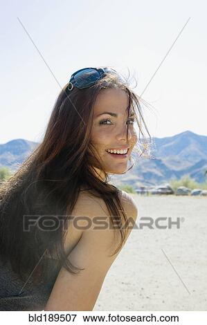 Hispanic woman with sunglasses smiling View Large Photo Image Stock Photo - Hispanic woman with sunglasses smiling. Fotosearch