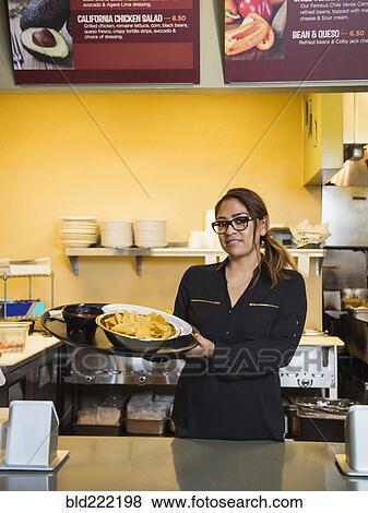 Stock Photo - Hispanic woman working in cafe. Fotosearch
