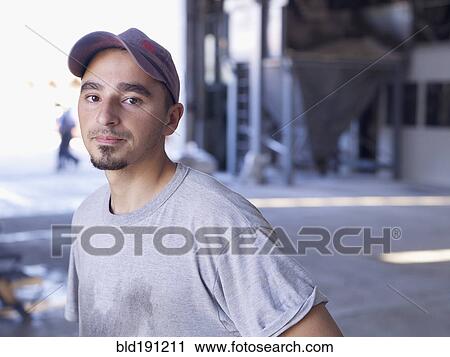 Stock Image - Hispanic worker in factory. Fotosearch