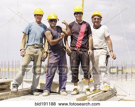 Hispanic workers standing on construction site View Large Photo Image Stock Photo - Hispanic workers standing on construction site. Fotosearch