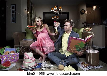 Stock Photograph - Husband indulging pregnant wife's food cravings. Fotosearch