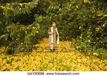 Stock Photo - Indian boy in front of trees. Fotosearch