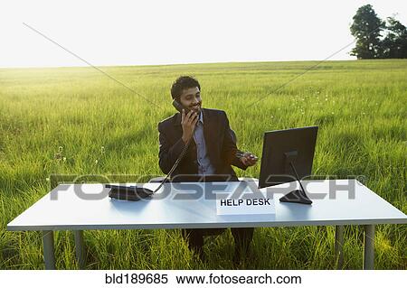 Stock Photography - Indian businessman at Help Desk in field. Fotosearch